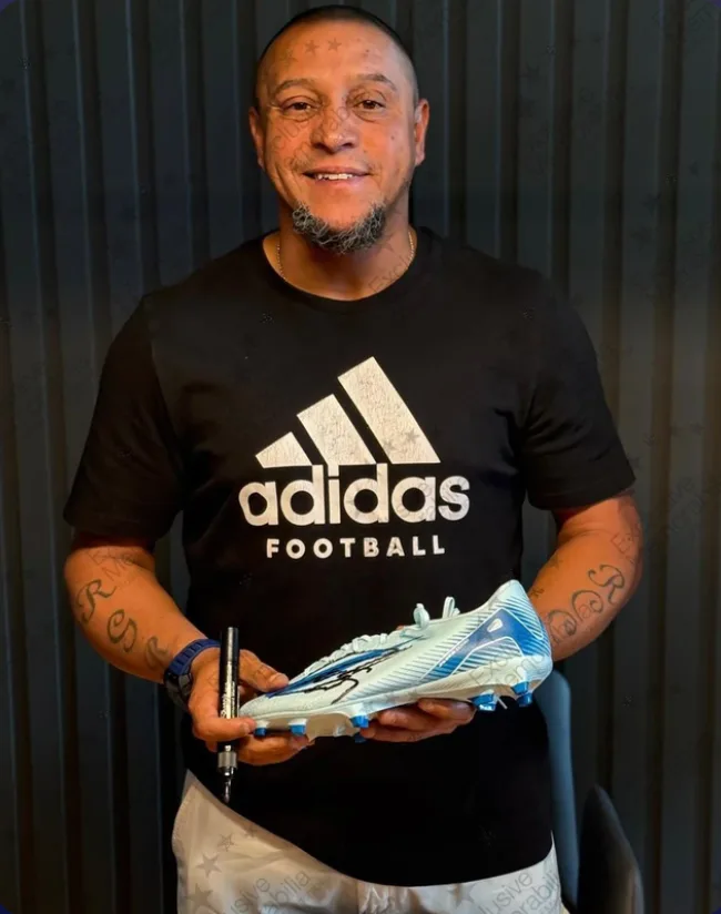 Roberto Carlos signing the boot this certificate covers